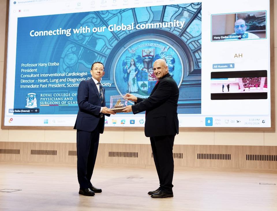 Professor Moe Oo being presented gift on behalf of College from RAKMHSU President Professor Matalka